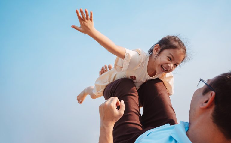 dad having fun with daughter - life insurance